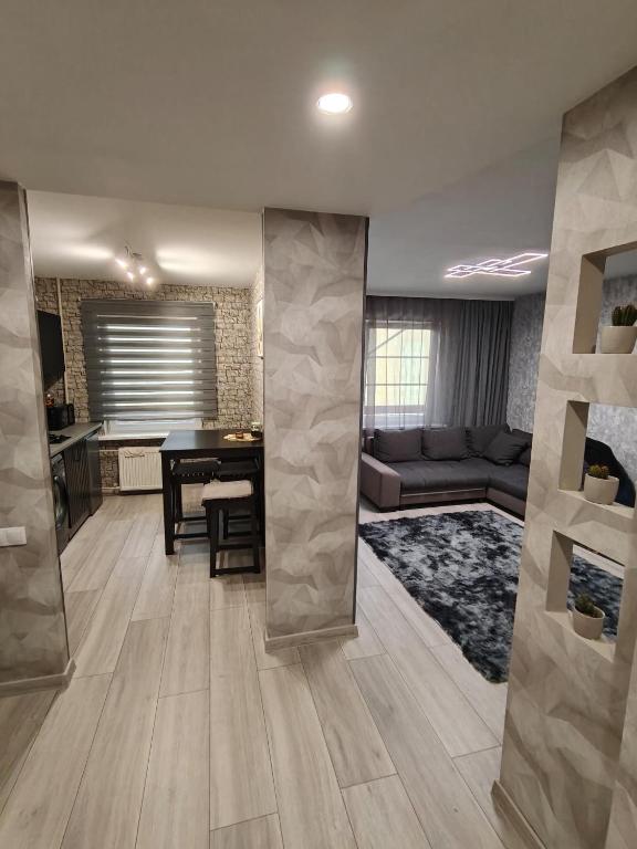 a living room with a couch and a table at Agnes Apartament in Valmiera