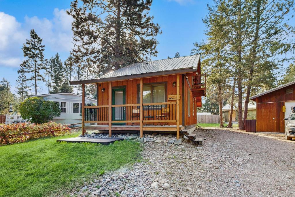 a large wooden cabin with a porch in a yard at Bear Chalet in Bigfork