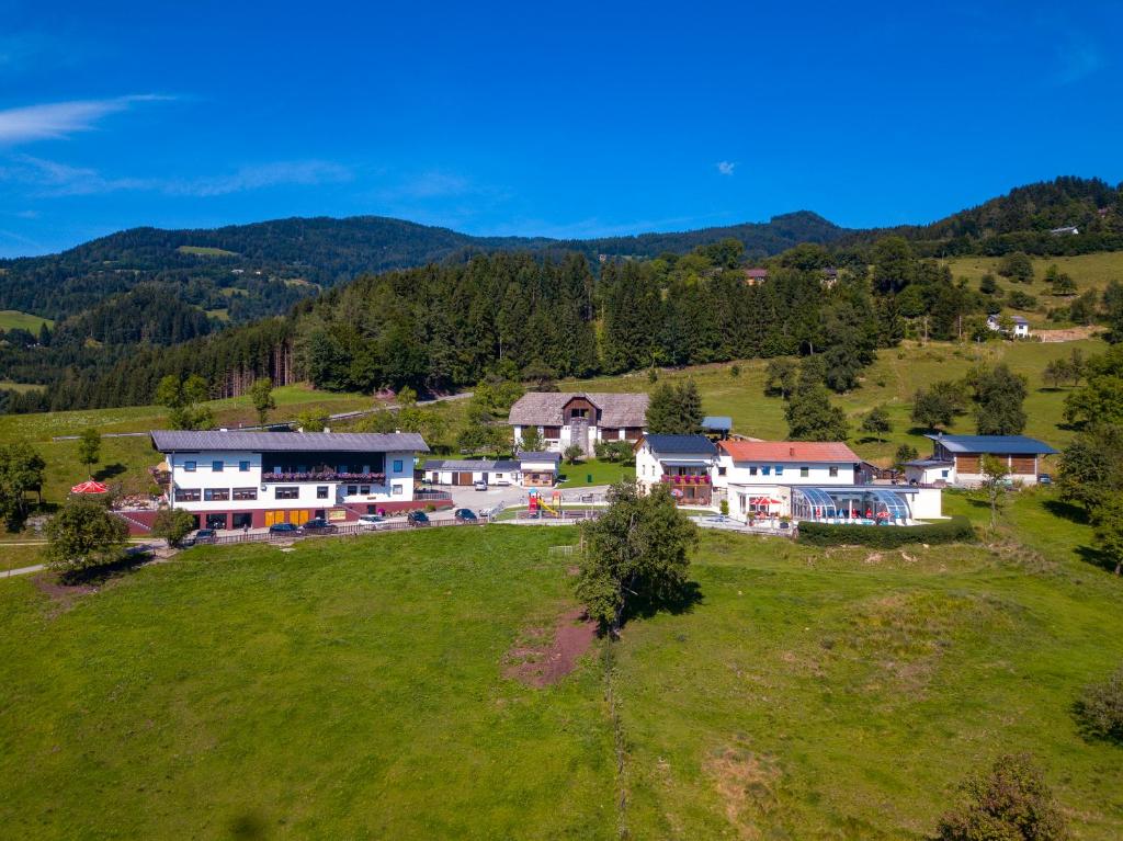 an aerial view of a house on a green field at Panorama Hof Sereinig in Sankt Oswald