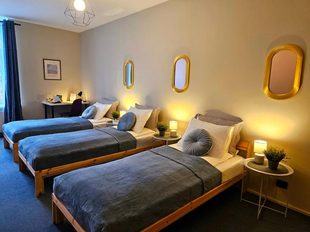 two beds in a room with mirrors on the wall at Old Town Cathedral Views - Steps from Dome Square -Friends & Family stay in Riga
