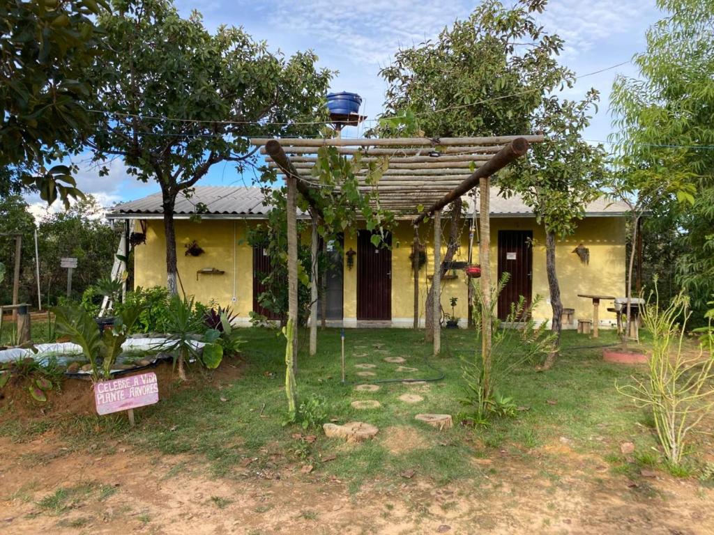 a small house with a pergola in front of it at COMPARTILHADO Do TERRÃO in Três Marias