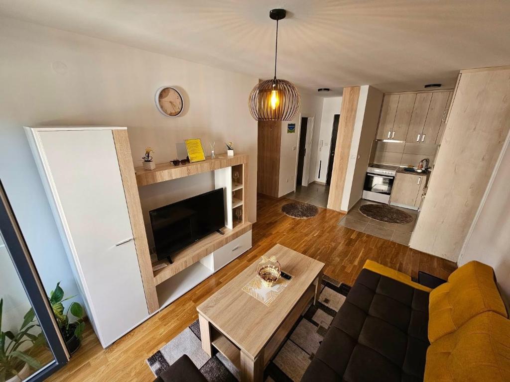 an open living room with a couch and a table at Garden Doboj in Doboj
