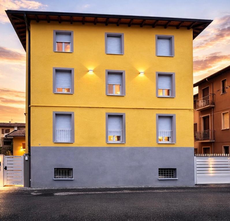 a yellow building with lights on the side of it at Palazzo Gregorio in Parma
