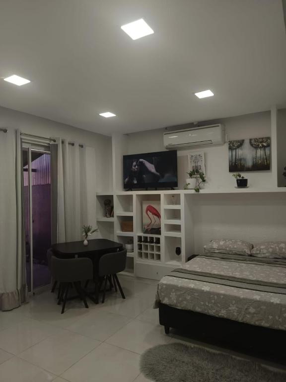 a bedroom with a bed and a table and a television at Monoambiente Dos Lunas in Resistencia