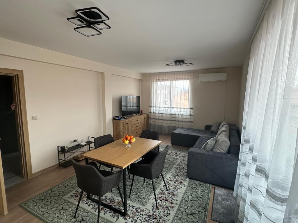 a living room with a table and a couch at Martin's Apartment in Bansko