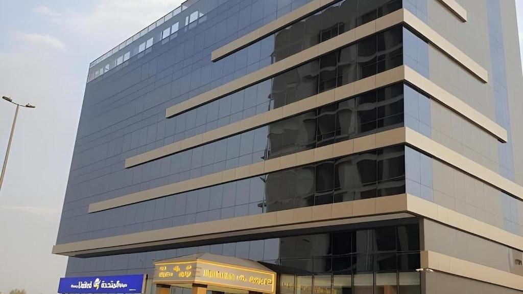 a tall building with a sign in front of it at فندق الريان Ryan Hotel in Jeddah