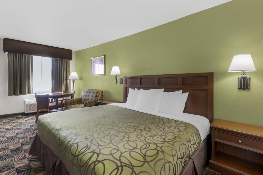 a hotel room with a bed and a desk at Best Western Caprock Inn in Brownfield