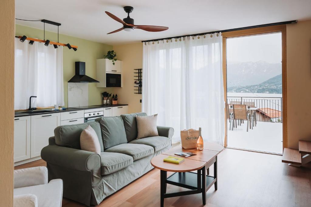a living room with a couch and a table at Tims Vista Bella - Mezzegra, Tremezzina by LoveComo in Lenno