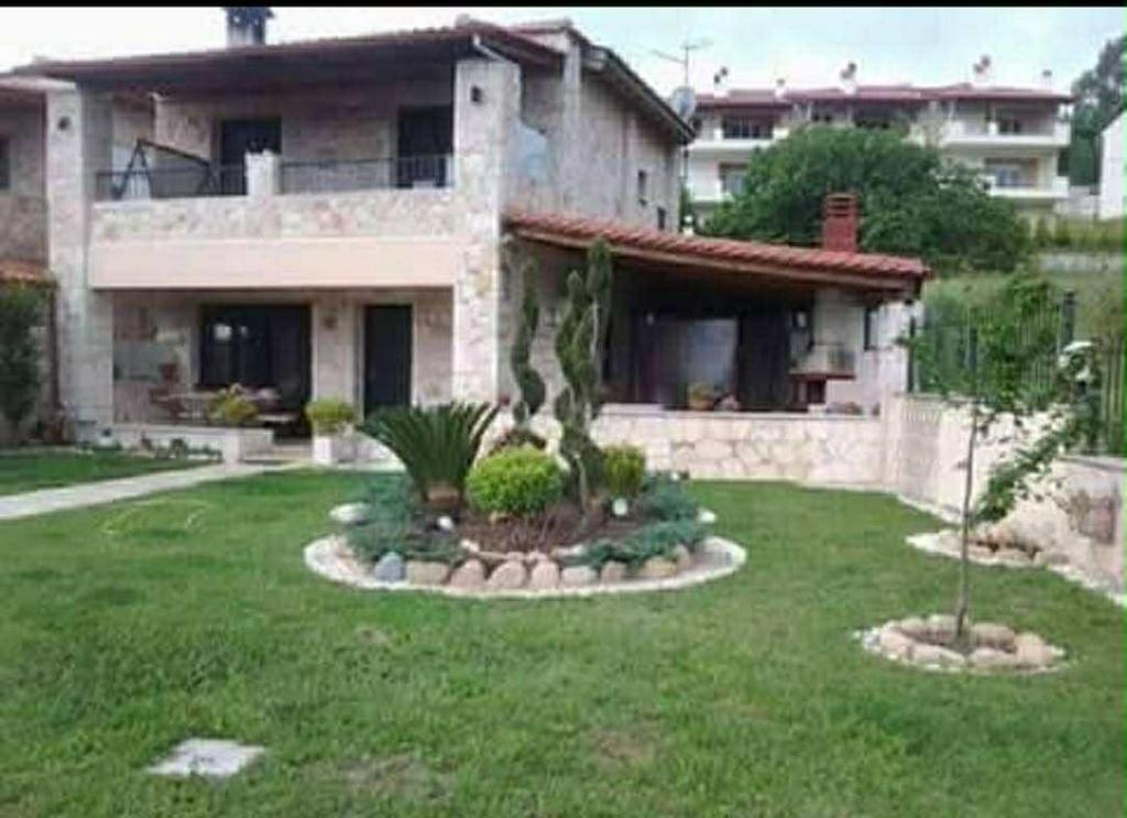 a large house with a yard in front of it at Villa Paliouri in Paliouri