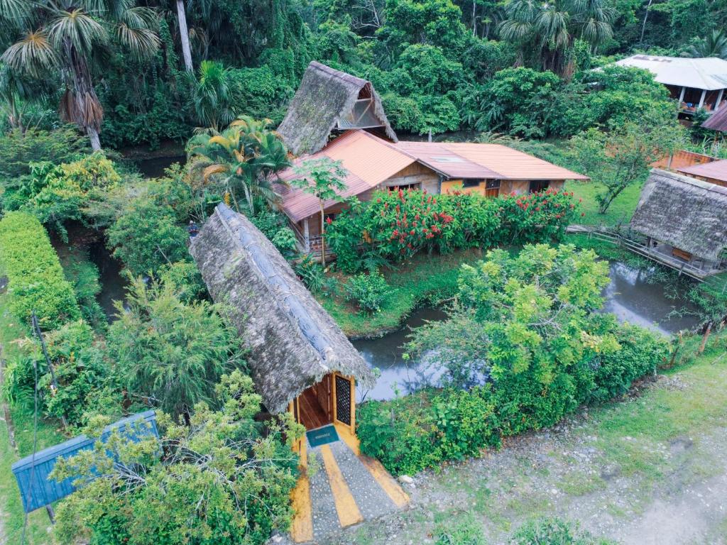 an aerial view of a house with a grass roof at Coati Lodge Misahualli in Tena