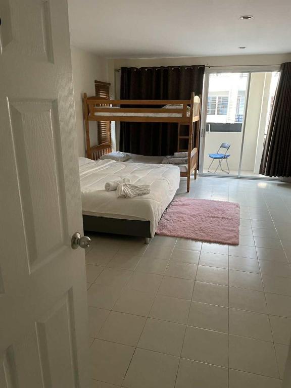a bedroom with a bed and a large window at M&M Kata Beach in Kata Beach