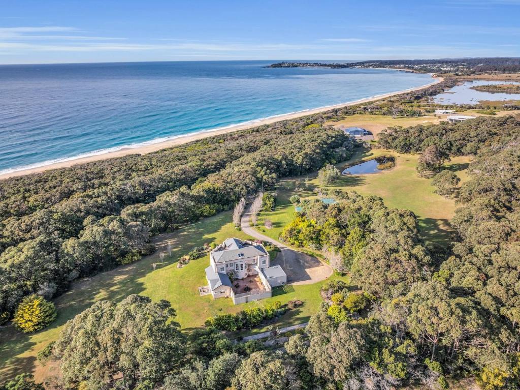 an aerial view of a large house on the beach at Castle by the Sea - Tilba Road 26 in Bermagui