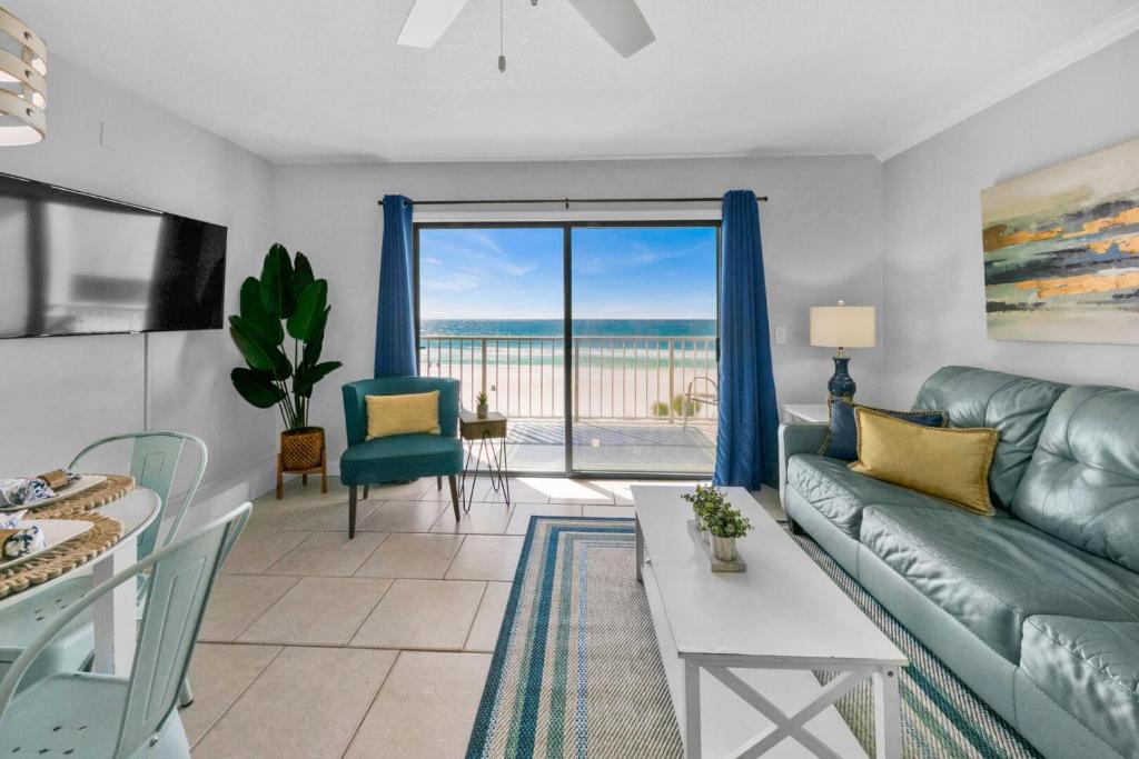 a living room with a couch and a table at Oceanfront Condo #507 at Summit Beach Resort in Panama City Beach