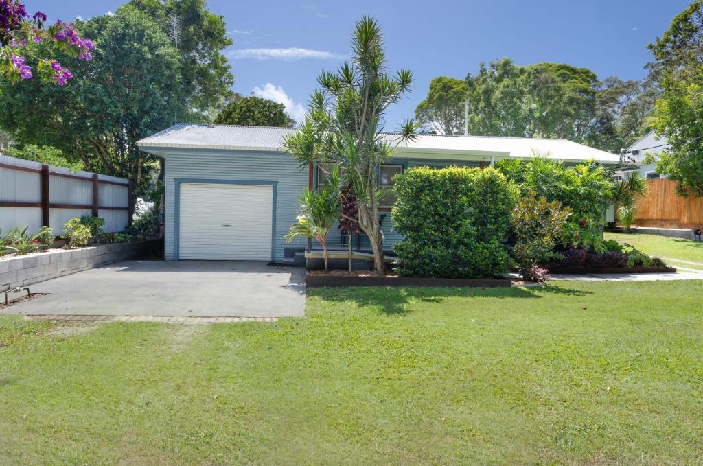 a house with a garage in a yard at Koala Lodge Cottage 5 in Iluka