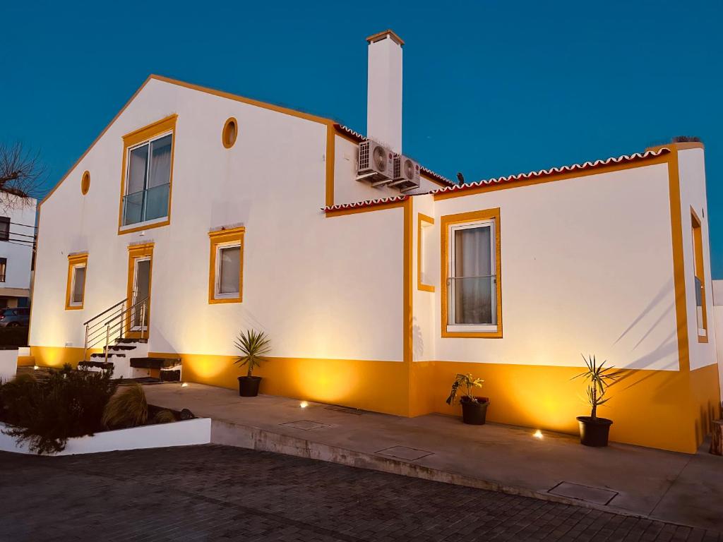 a white house with plants in front of it at Azorescape in Lagoa