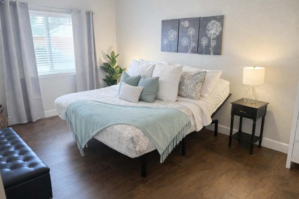 a bedroom with a large bed with pillows at Condo with Sauna & Fitness Center, Adjustable Base King Sized Bed in Coeur d'Alene