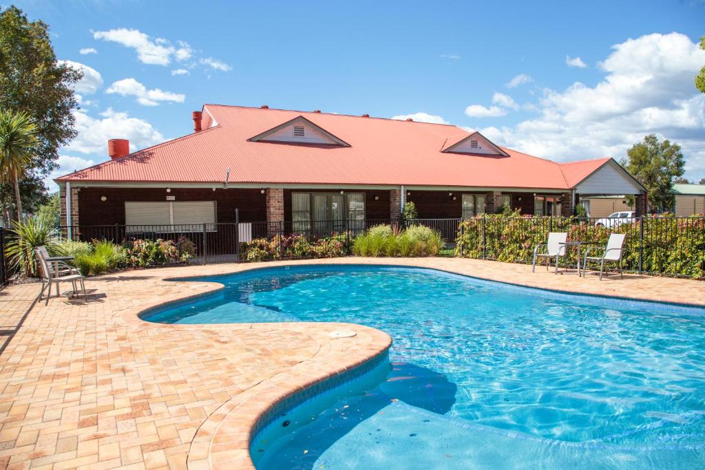 a swimming pool in front of a house at Nepean by Gateway Lifestyle Holiday Parks in Penrith