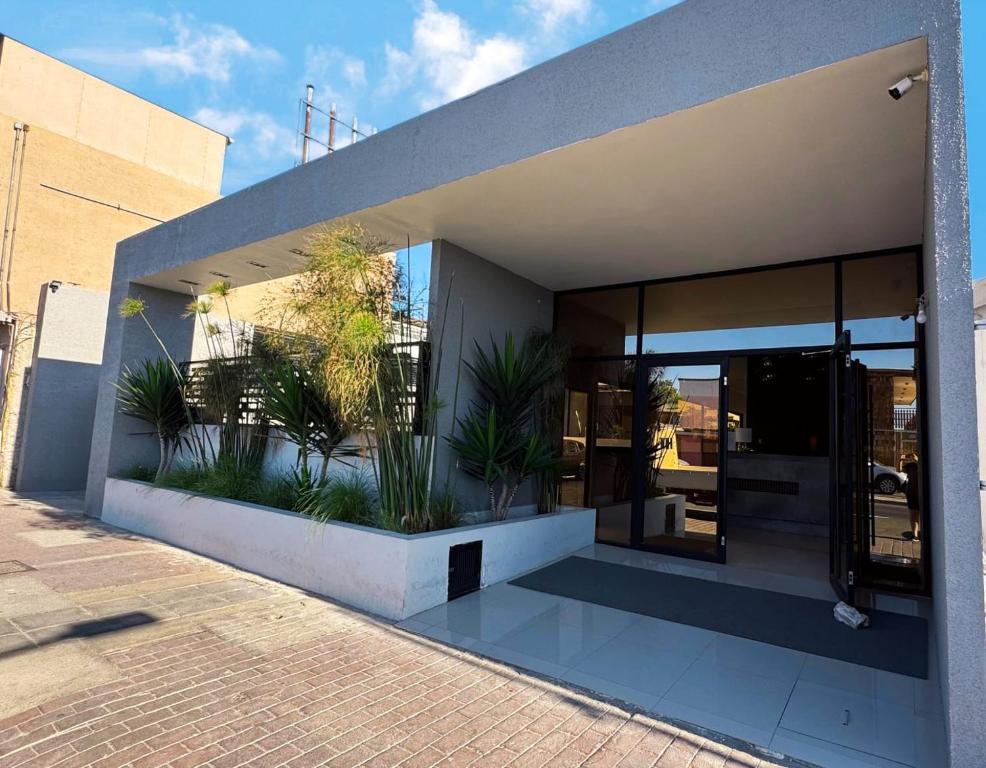 a building with plants on the side of it at Hotel Marluz in Mejillones