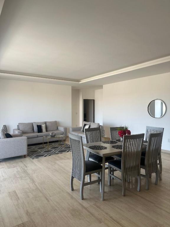 a living room with a table and chairs and a couch at Departamento en Yatay Towers in Hércules