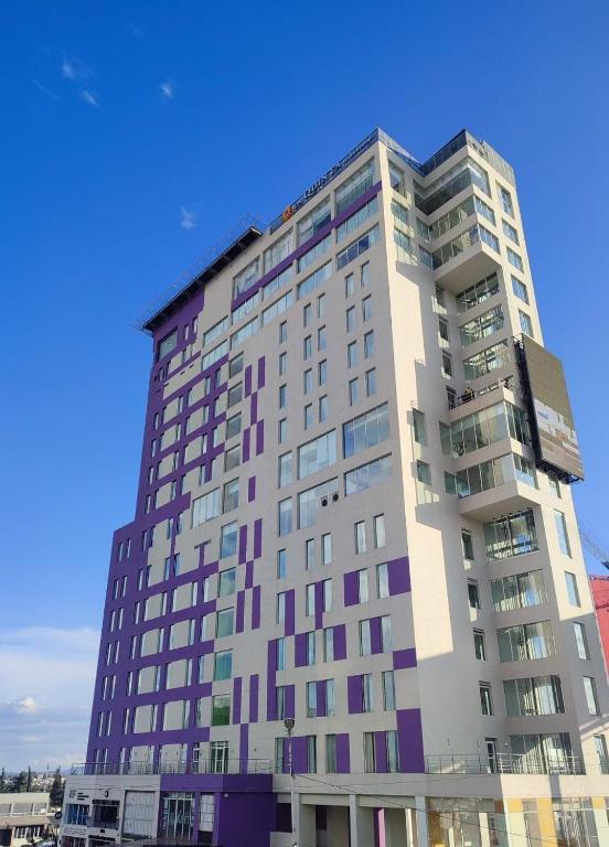a tall building with many windows on top of it at La Quinta by Wyndham Puebla Palmas Angelopolis in Puebla
