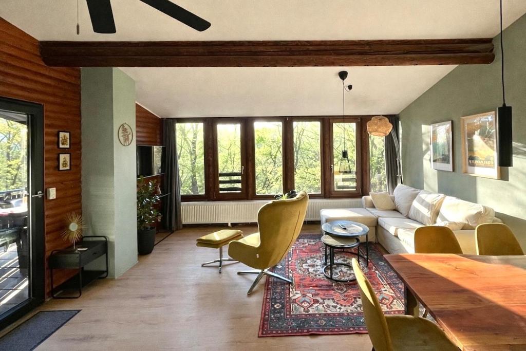 a living room with a couch and chairs and a table at Baumhausfeeling im Wald nahe der Loreley in Bogel
