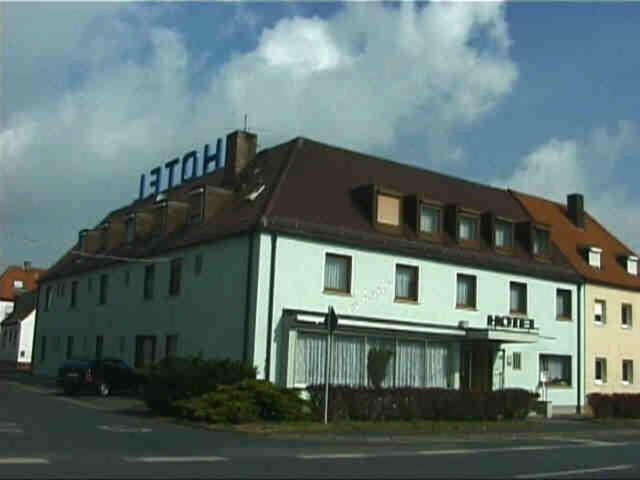 a white building with a sign on top of it at Hotel Astoria in Bergrheinfeld