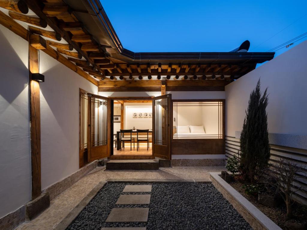 an entrance to a home with a pergola at Luxury Hanok The four beauties seochon in Seoul