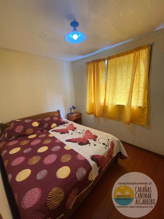 a bedroom with a bed and a window at cabañas canemar in Hueyilemu