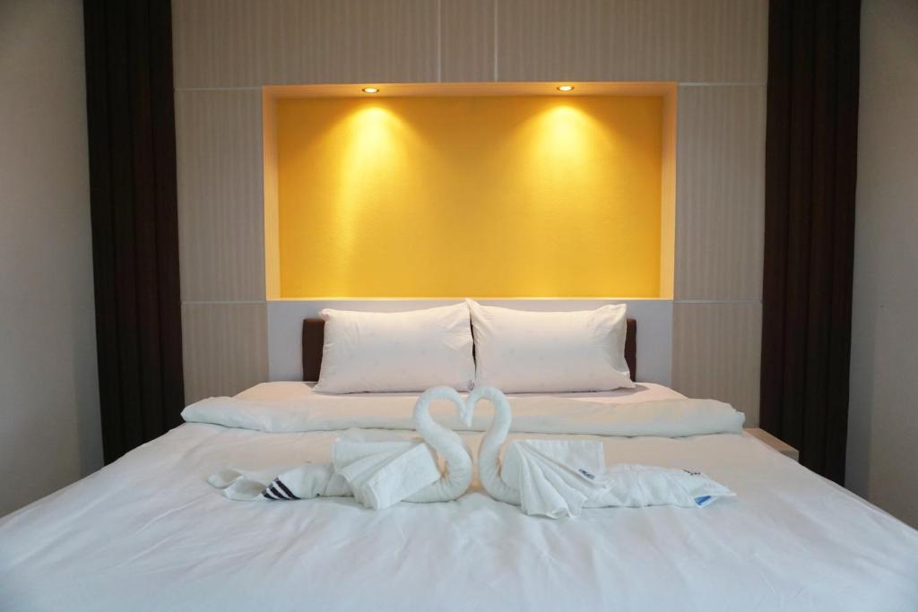 Postel nebo postele na pokoji v ubytování Honey Hotel Chiang Saen