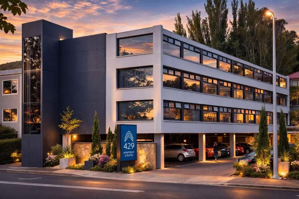a large white building with a parking lot at 429 Apartments & Suites in Hobart