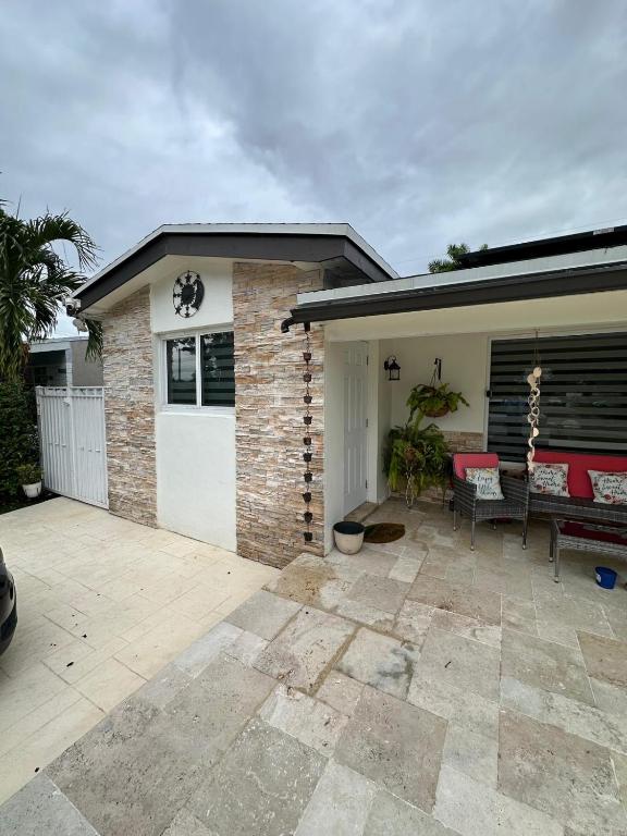 a house with a garage with a white garage door at Miramar's Studio in Miramar