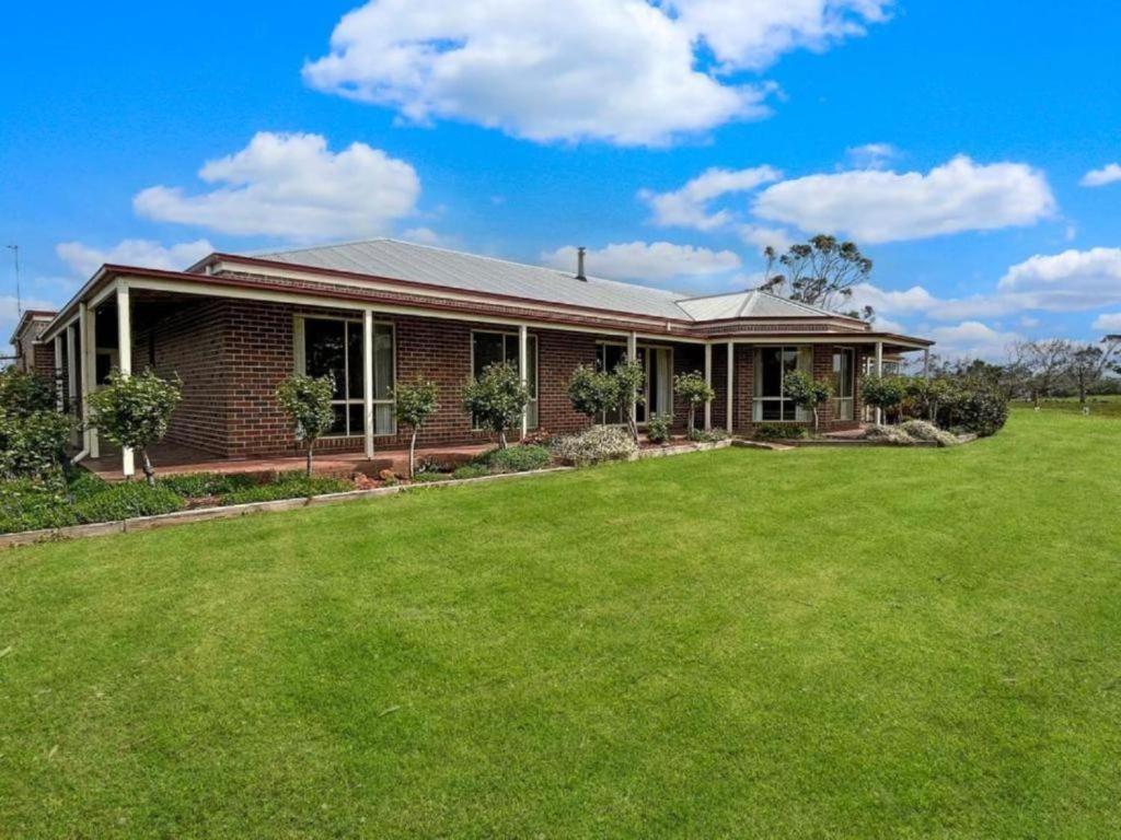 a house with a large lawn in front of it at Roses Farmhouse in Heathmere