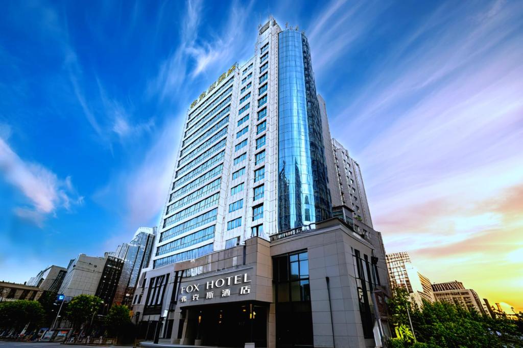 a tall building with a sign on the front of it at 弗克斯酒店 in Zunyi