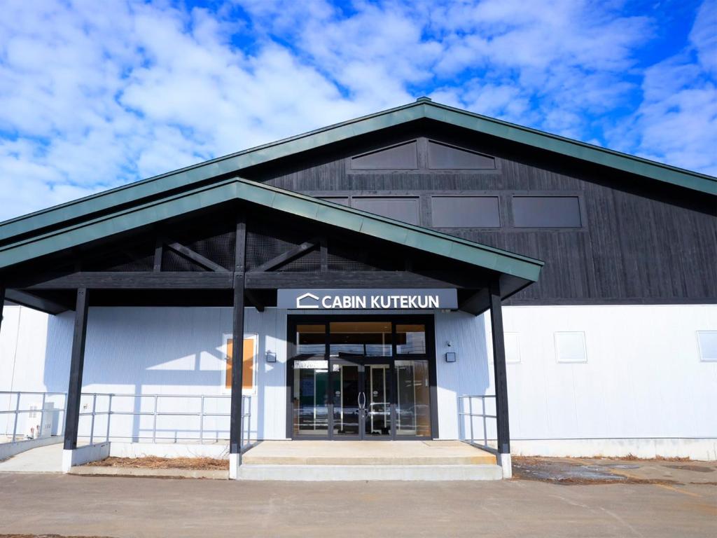 a building with a sign that reads cedar kitchen at Cabin kutekun in Naka-shibetsu
