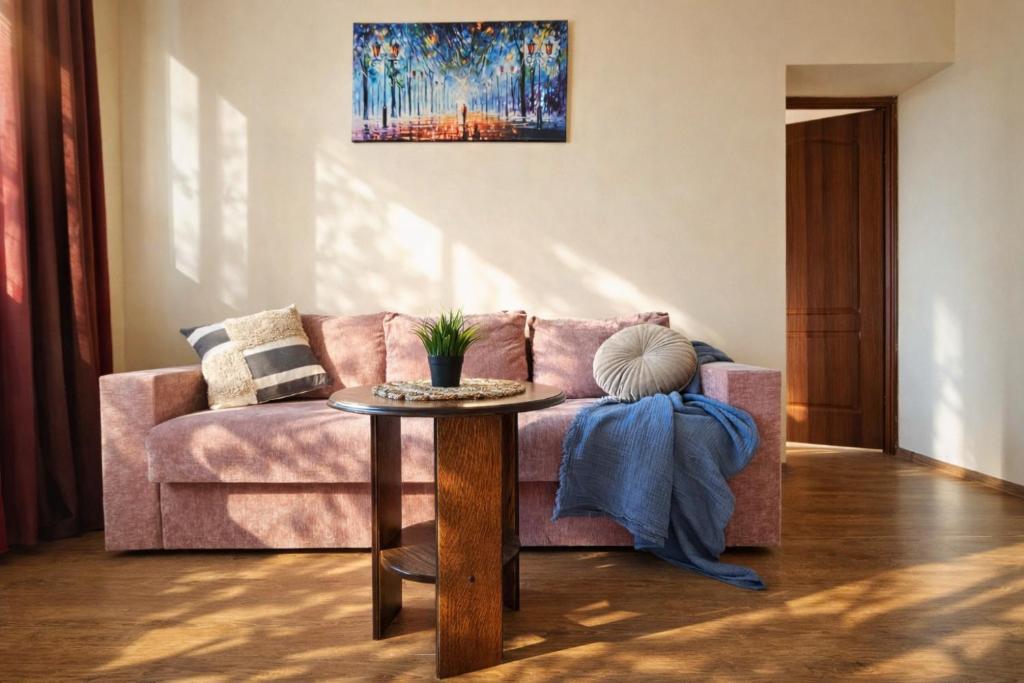 a living room with a pink couch and a table at Best Two Room Apartment in Mukacheve