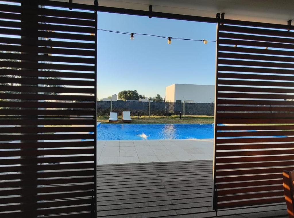 a view of a pool through a sliding glass door at Quinta Soñada Junin in Junín