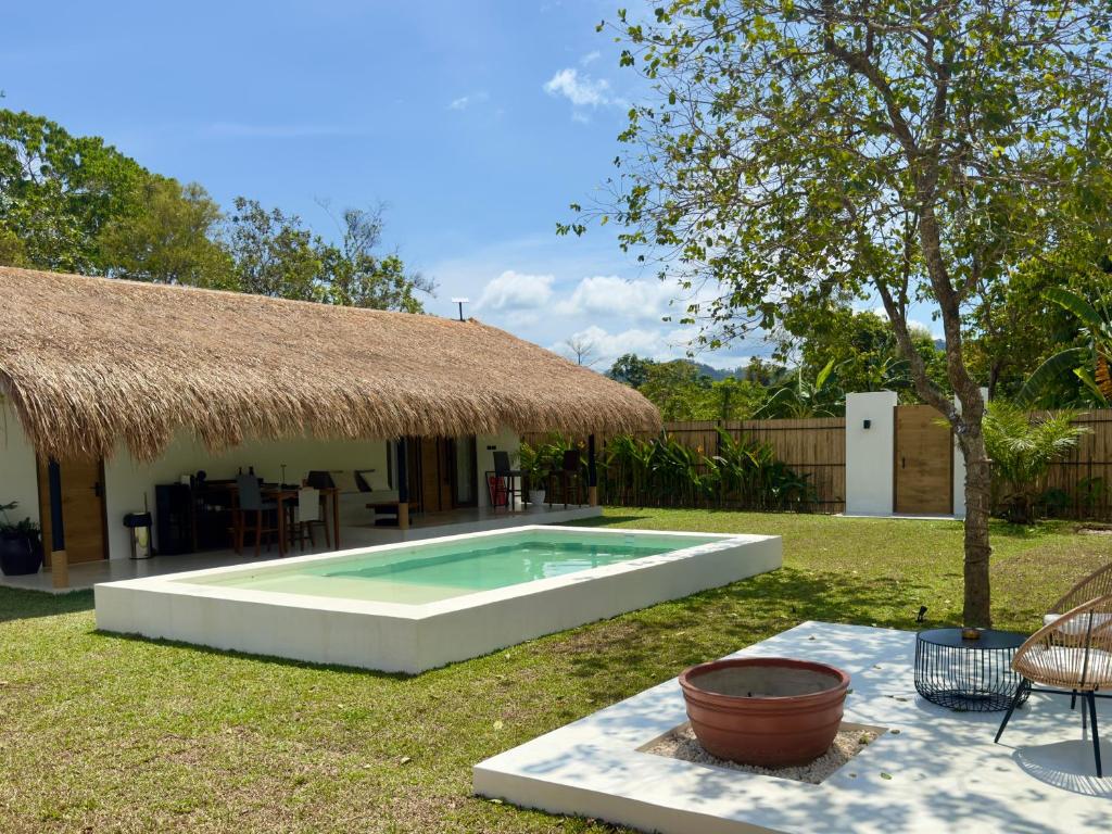 a swimming pool in the yard of a house at Lasa, private villa with private pool in El Nido
