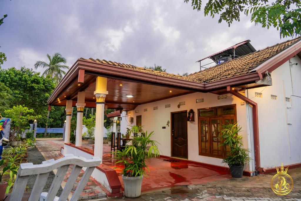 a small white house with a roof at T P Villas in Nilaveli