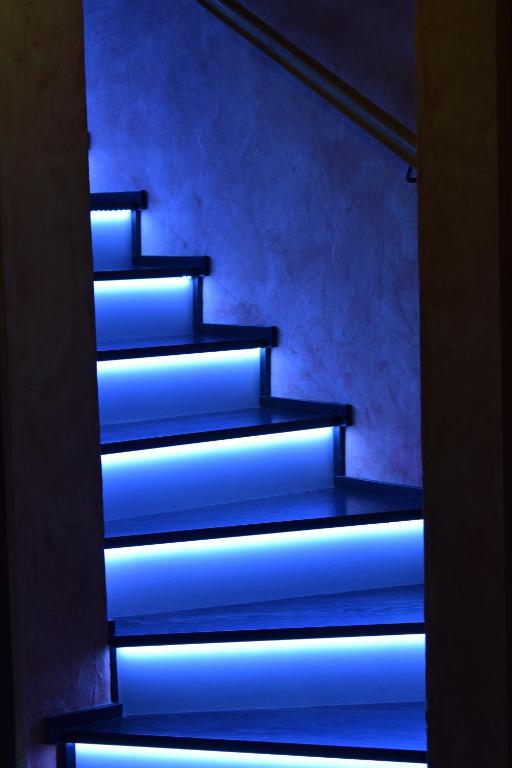 a set of stairs with blue lights on them at Apartment Borovnica in Moravske-Toplice