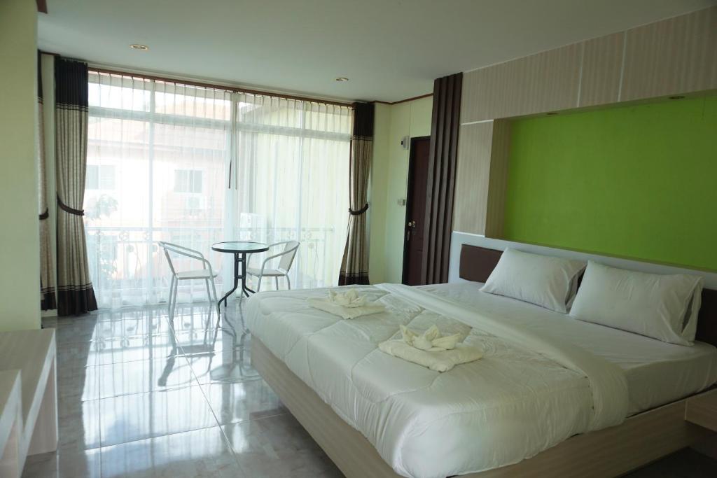 Postel nebo postele na pokoji v ubytování Honey Hotel Chiang Saen