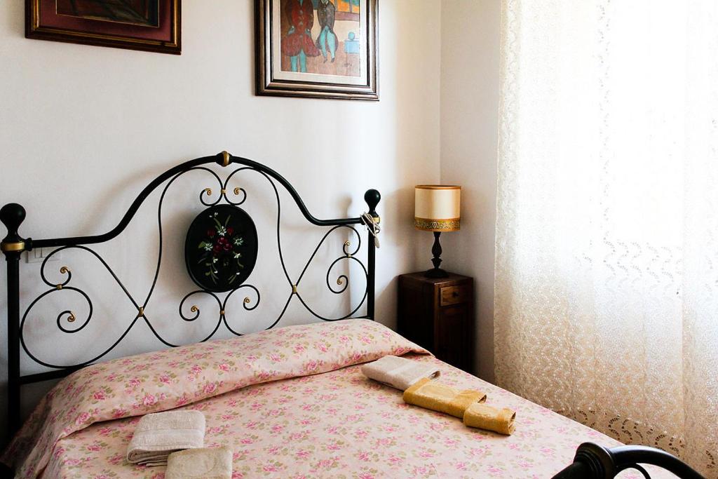 1 dormitorio con 1 cama con colcha en blanco y negro en Guesthouse Stazione Pisa Centro, en Pisa