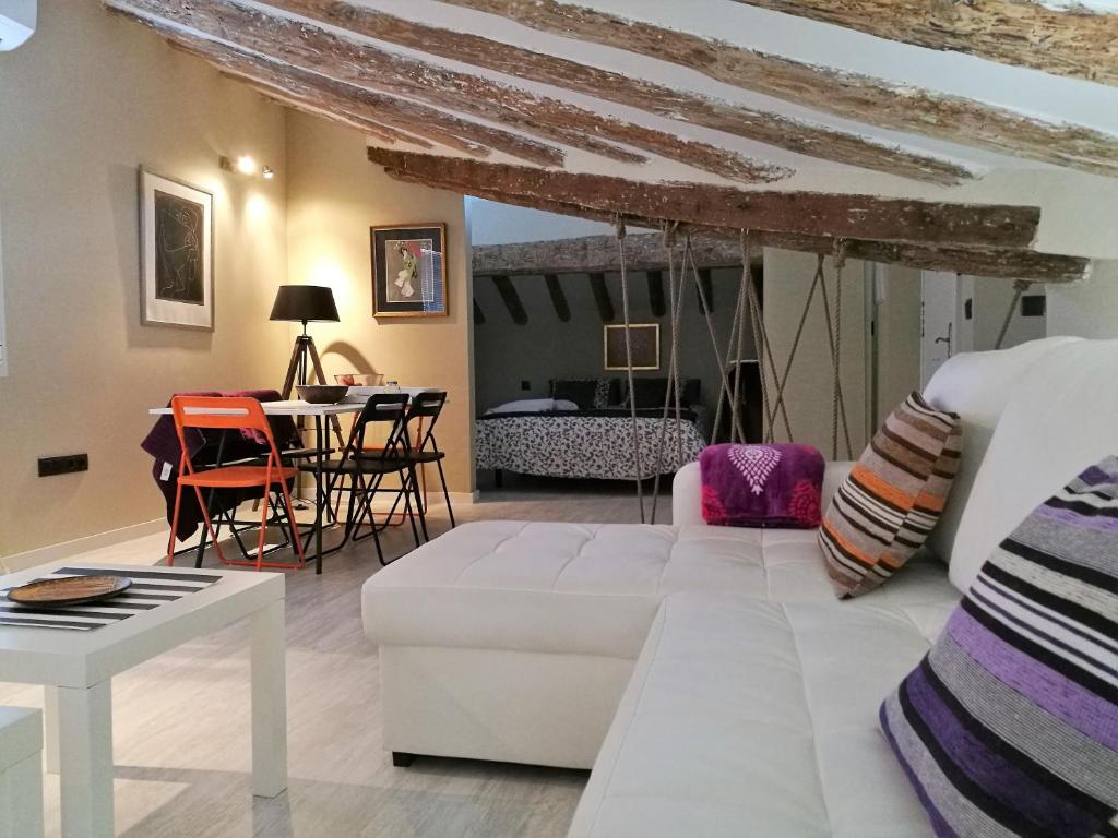 a living room with a white couch and a table at 18 Torres in Zaragoza