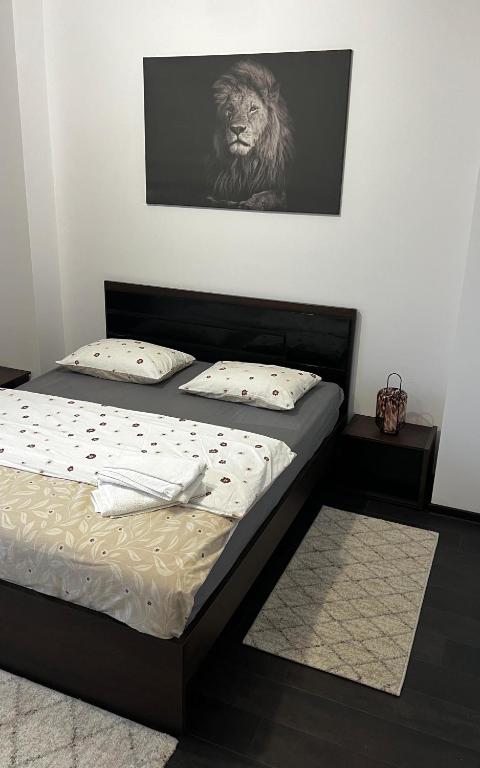 a bedroom with a bed with a lion on the wall at SCC2 Apartments in Cluj-Napoca