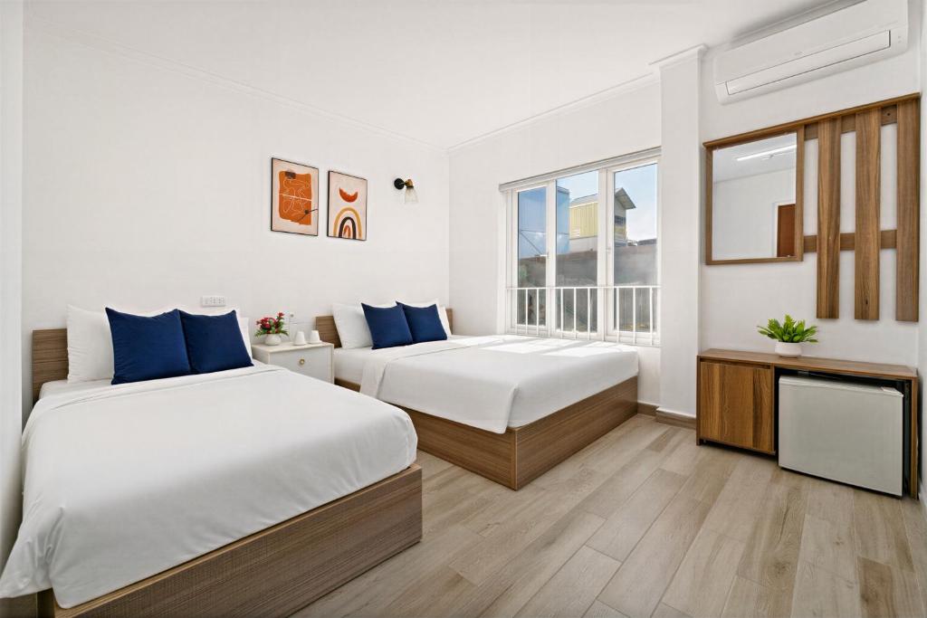 a hotel room with two beds and a television at Miah Ha Noi Hotel - the best choice in Hà Nội Old Quarter in Hanoi