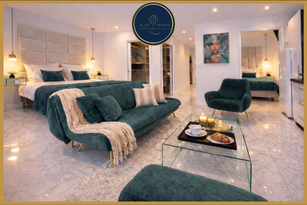 a living room with a bed and a green couch at Luxury Maubourg - Vue mer - Croisette 50m plage - Clim - terrasse in Cannes