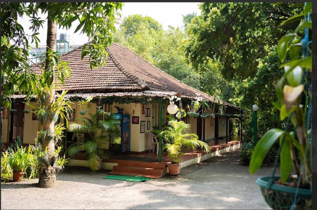 a small house with plants in front of it at Palm Grove Service Villa in Cochin