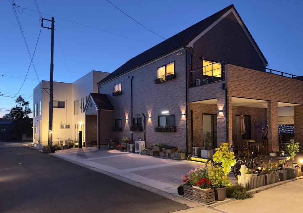 a large brick building with lights on at The Bear ベアSpacious Holiday Villa in Inzai