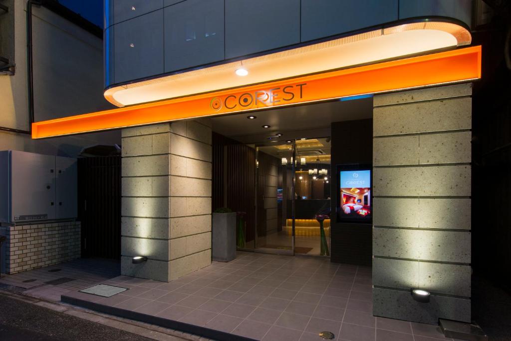 a building with an orange sign on the front of it at Hotel COREST (Adult Only) in Tokyo