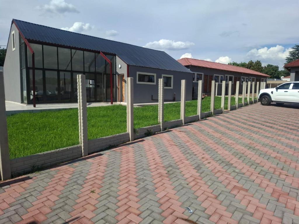 a brick driveway in front of a building at Nu Oasis guest house in Johannesburg