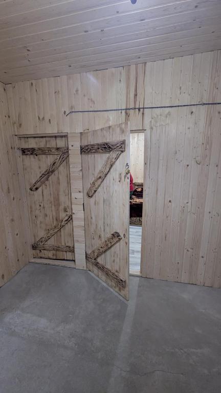 an empty room with two doors in a barn at Байк Пост Т67 in Rakovo